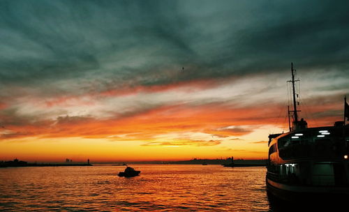 Boat in sea at sunset