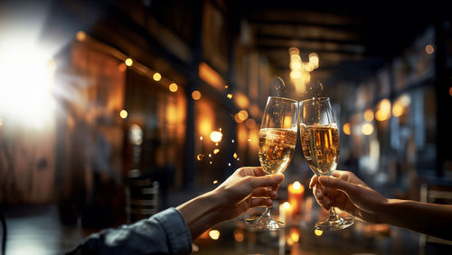 Cropped hand of woman holding champagne flute