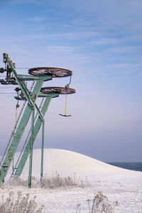 Amusement park ride against sky