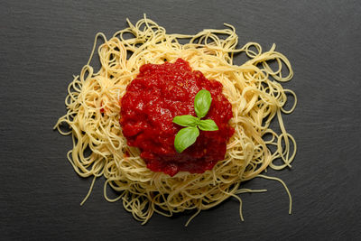 Directly above shot of strawberry on plate against black background