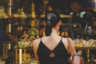 Rear view of woman doing window shopping