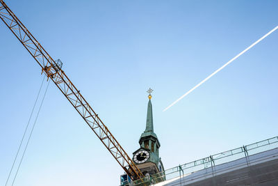 Low angle view of crane against clear sky