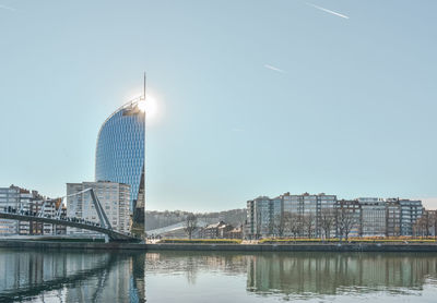 Bridge over river with buildings in background