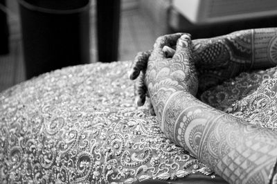 Midsection of woman with heena tattoo during wedding ceremony