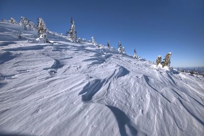 Snowcapped mountain against clear blue sky