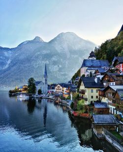 River amidst buildings in town against sky