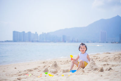 Portrait of boy on beach against sky