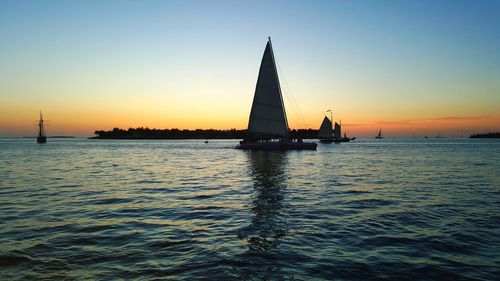 Silhouette of sailboat sailing on sea