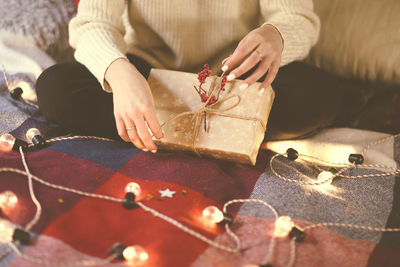 Midsection of woman holding christmas decorations