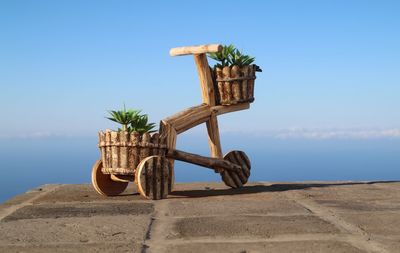 Wooden bike  against clear blue sky