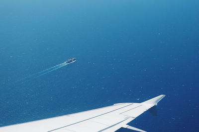 Airplane flying against blue sky