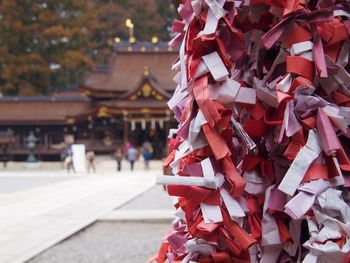 Close-up of red bell hanging outside temple