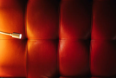 Red padded leather wall with light