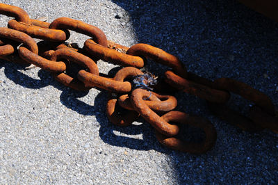 High angle view of rusty chain on street