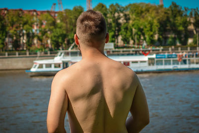 Rear view of shirtless boy in swimming pool