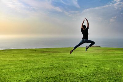 Young man jumping on beach