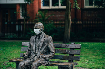 Statue on bench in park