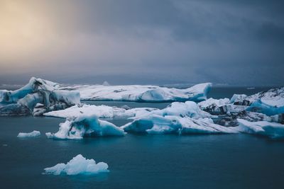 Frozen lake against sky during winter