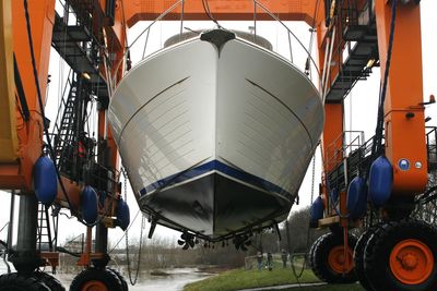 Boat hanging in a crane 
