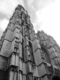 Low angle view of building against cloudy sky