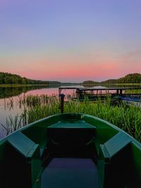 Scenic view of lake against clear sky during sunset