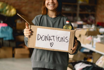 Volunteer teengirl preparing donation boxes for people.