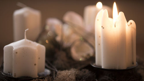 High angle close-up of glowing candle during christmas