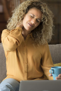 Young woman using laptop at home