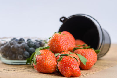 Close-up of strawberries on table against white background