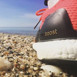 Close-up of text on beach against sky