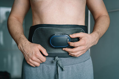 Midsection of man holding jeans