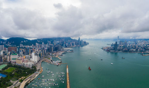 High angle view of buildings by sea against sky