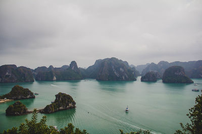 Scenic view of sea and mountains against sky