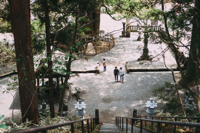 High angle view of people on railing against trees