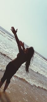 Low angle view of person at beach against sky