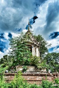 Low angle view of temple against cloudy sky