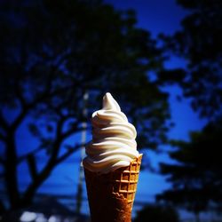 Close-up of ice cream cone against sky