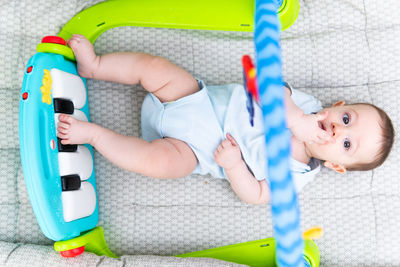 Directly above shot of baby lying on bed