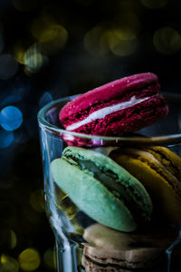 Close-up of multi colored macaroon in glass jar