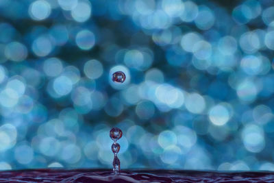 Close-up of drop falling on water