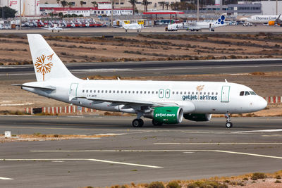 High angle view of airplane on airport runway