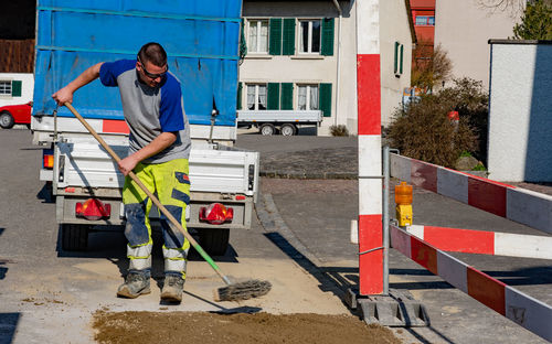 Smiling worker working at road