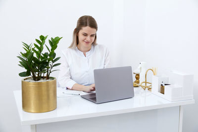 Young woman using laptop at home