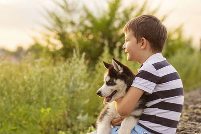 Side view of boy with dog