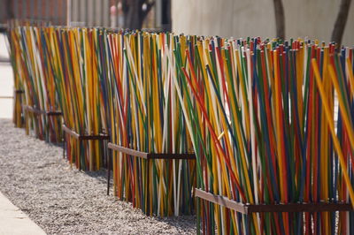 Close-up of multi colored row on sand at beach