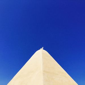 Low angle view of built structure against blue sky