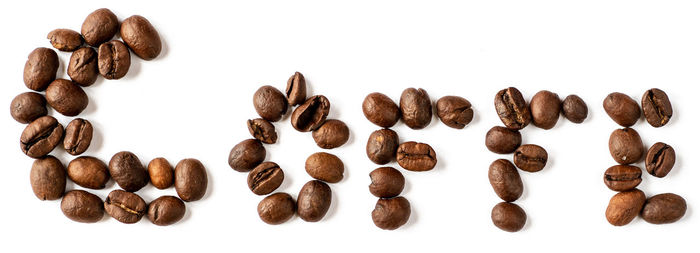 Close-up of coffee beans against white background