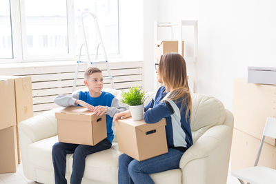 Young woman sitting in box