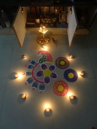 High angle view of illuminated christmas lights on floor at home