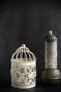 Close-up of electric lamp on table against black background